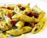 Penne z pesto i kawałkami suszonych pomidorów, posypane parmezanem. Pyszne danie, które zachwyci każdego miłośnika makaronu.